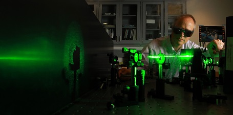 Man in Lab Goggles Using Green Laser Beam